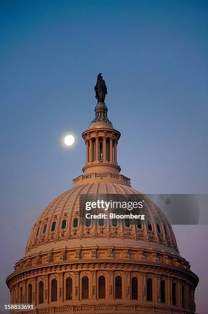 Dawn breaks at the U.S. Capitol in Washington, D.C., U.S., on Monday, Dec. 31, 2012. U.S. Lawmakers hurtled toward a midnight deadline to avert...