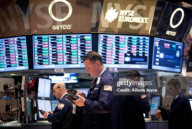 Traders work on the floor of the New York Stock Exchange December 31, 2012 in New York City. US lawmakers are struggling to work out a last-minute...