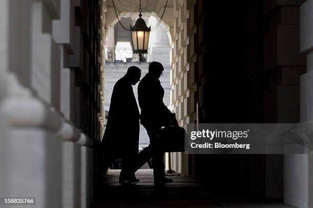 Senator Harry Reid, a Democrat from Nevada, left, walks into the U.S. Capitol in Washington, D.C., U.S., on Monday, Dec. 31, 2012. U.S. Lawmakers...