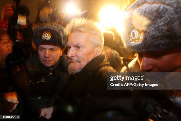 Russian police officers arrest Eduard Limonov , one of the current leaders of the Russian opposition movement, during an opposition protest in...