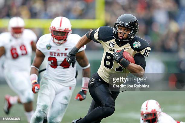 Jordan Matthews of the Vanderbilt Commodores heads toward the end zone for an 18-yard touchdown catch and run against the North Carolina State...
