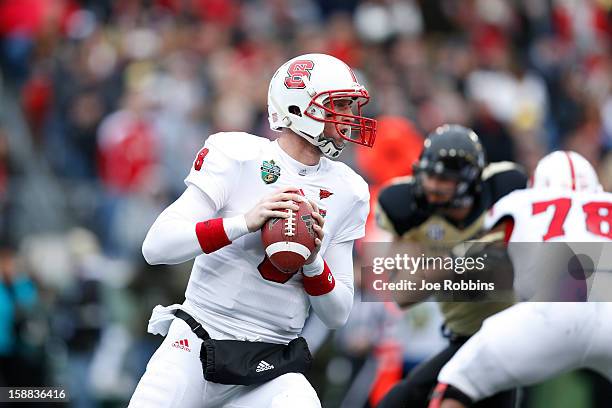 Mike Glennon of the North Carolina State Wolfpack looks to pass the ball against the Vanderbilt Commodores during the Franklin American Mortgage...