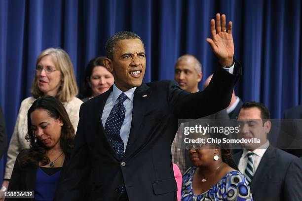 President Barack Obama waves goodbye after delivering remarks about the fiscal cliff negotiations in the Eisenhower Executive Office Building next to...