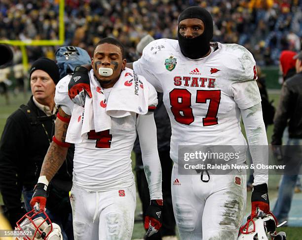 State wide receiver Tobais Palmer and tight end Mario Carter walk off the field after N.C. State's 38-24 loss to Vanderbilt in the Franklin American...