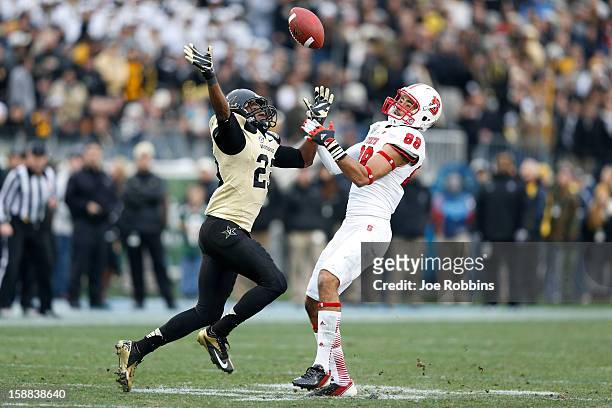 Andre Hall of the Vanderbilt Commodores defenses a pass intended for Quintin Payton of the North Carolina State Wolfpack during the Franklin American...