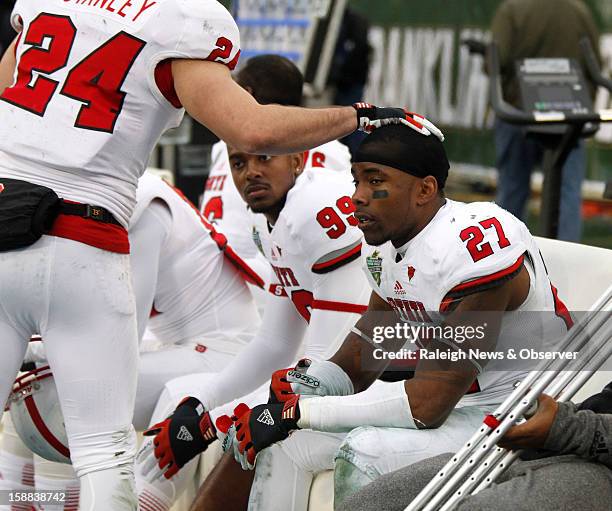 State senior safety Earl Wolff sits on the bench late in the second half of the Franklin American Mortgage Music City Bowl at LP Field in Nashville,...