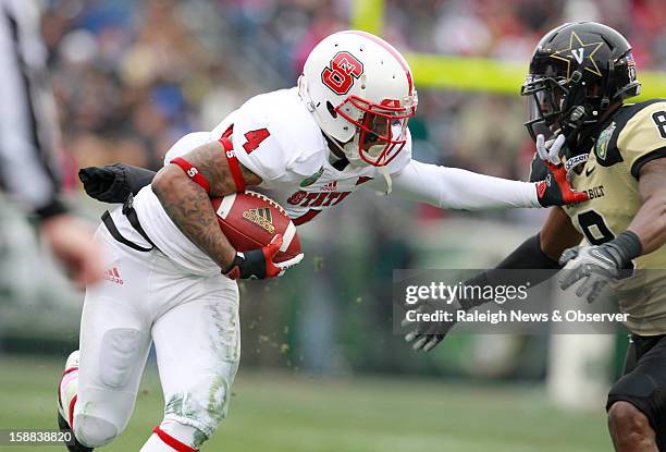 State wide receiver Tobais Palmer stiff-arms Vanderbilt defensive back Trey Wilson during the first half of the Franklin American Mortgage Music City...