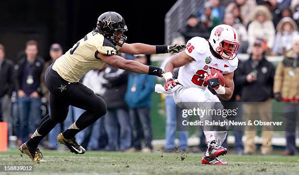 State running back Tony Creecy runs by Vanderbilt linebacker Archibald Barnes during the first half of the Franklin American Mortgage Music City Bowl...