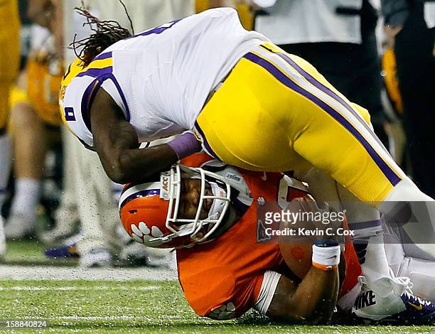 Craig Loston of the LSU Tigers tackles Tajh Boyd of the Clemson Tigers during the 2012 Chick-fil-A Bowl at Georgia Dome on December 31, 2012 in...