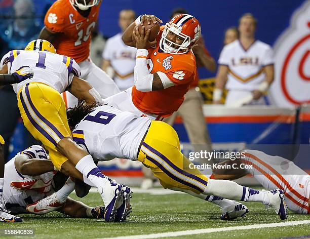 Tajh Boyd of the Clemson Tigers dives for a touchdown over Craig Loston of the LSU Tigers during the 2012 Chick-fil-A Bowl at Georgia Dome on...