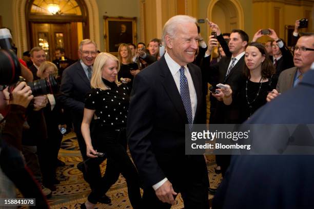 Vice President Joe Biden arrives to a Democratic caucus meeting with Senator Harry Reid, a Democrat from Nevada, left, at the U.S. Capitol in...