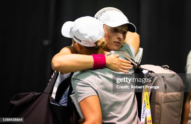 Iga Swiatek of Poland embraces psychologist Daria Abramowicz before the second round on Day 3 of the National Bank Open Montréal at Stade IGA on...