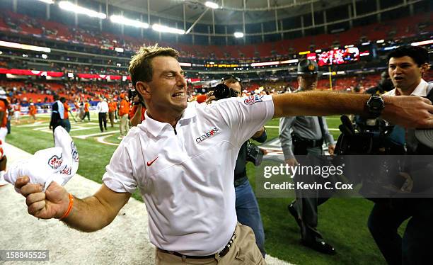 Head coach Dabo Swinney of the Clemson Tigers celebrates their 25-24 win over the LSU Tigers during the 2012 Chick-fil-A Bowl at Georgia Dome on...