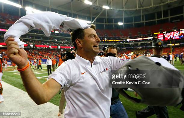 Head coach Dabo Swinney of the Clemson Tigers celebrates their 25-24 win over the LSU Tigers during the 2012 Chick-fil-A Bowl at Georgia Dome on...