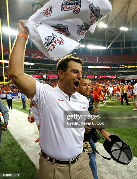 Head coach Dabo Swinney of the Clemson Tigers celebrates their 25-24 win over the LSU Tigers during the 2012 Chick-fil-A Bowl at Georgia Dome on...