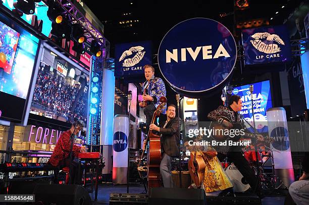 Cast members from "Million Dollar Quartet" perform on the NIVEA Kiss Stage in Times Square on New Year's Eve 2013 on December 31, 2012 in New York...