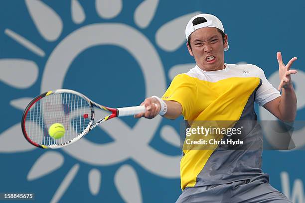 Tatsuma Ito of Japan plays a forehand during his match against John Millman of Australia on day three of the Brisbane International at Pat Rafter...