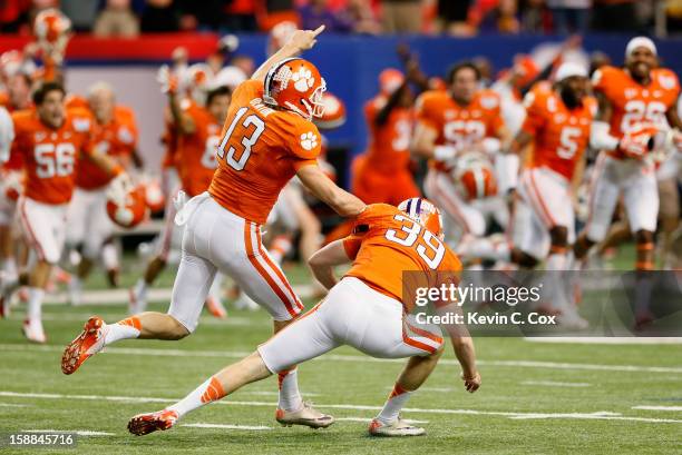 Chandler Catanzaro of the Clemson Tigers reacts with Spencer Benton after kicking the game-winning field goal against the LSU Tigers during the 2012...