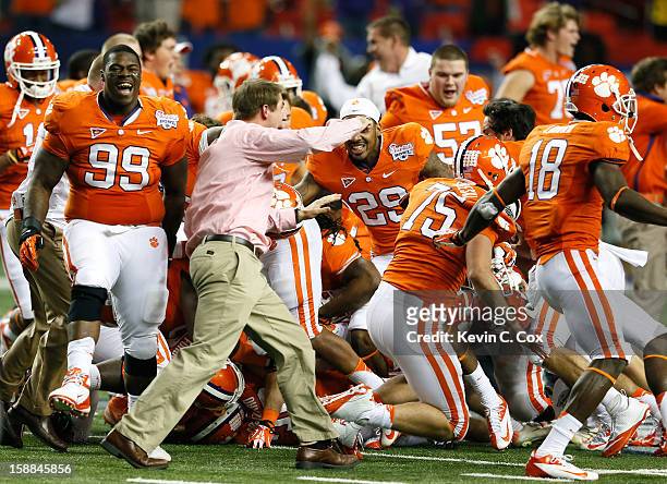 The Clemson Tigers celebrate their 25-24 win over the LSU Tigers during the 2012 Chick-fil-A Bowl at Georgia Dome on December 31, 2012 in Atlanta,...