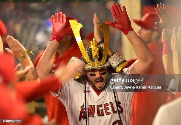 Mike Moustakas of the Los Angeles Angels is greeted in the dugout after hitting a three run home run in the sixth inning against the San Francisco...