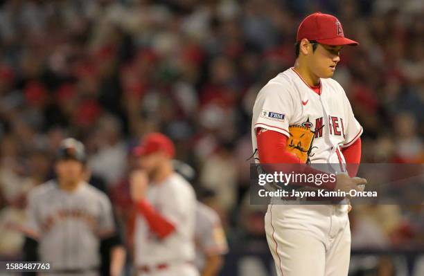 Shohei Ohtani of the Los Angeles Angels reacts on the mound after hitting Wilmer Flores of the San Francisco Giants with a pitch in the sixth inning...