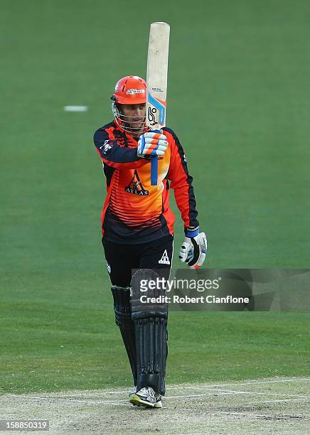 Simon Katich of the Scorchers raises his bat after he scored his half century during the Big Bash League match between the Hobart Hurricanes and the...