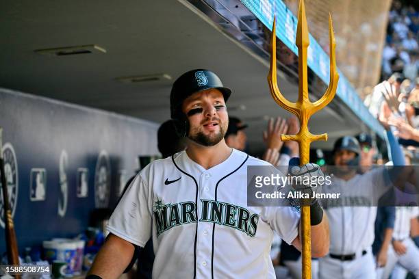 Cal Raleigh of the Seattle Mariners celebrates in the dugout with teammates after hitting a two-run home run during the sixth inning against the...