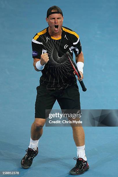 Lleyton Hewitt of Australia celebrates winning his match against Igor Kunitsyn of Russia on day three of the Brisbane International at Pat Rafter...