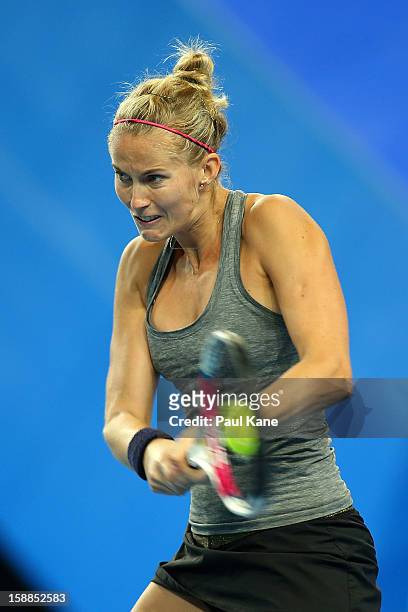 Mathilde Johansson of France plays a backhand to Venus Williams of the USA in her singles match during day four of the Hopman Cup at Perth Arena on...
