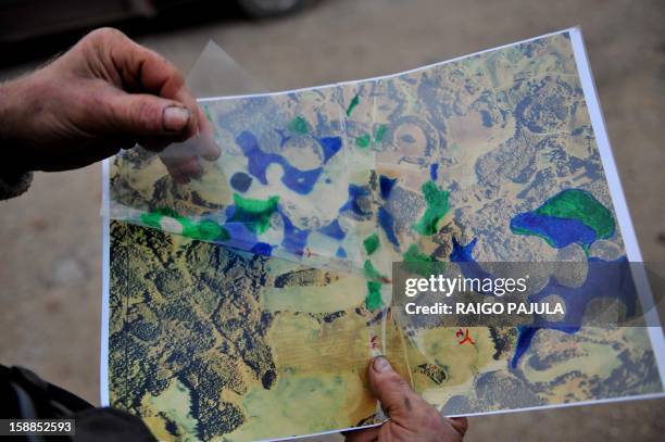 Anneli REIGAS Leigo music festival organizer, Estonian farmer Tonu Tamm who created 14 artificial lakes shows a map of his land before and after on...