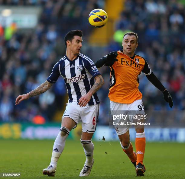 Liam Ridgewell of West Bromwich Albion is tackled by Dimitar Berbatov of Fulham during the Barclays Premier League match between West Bromwich Albion...