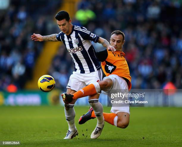 Liam Ridgewell of West Bromwich Albion is tackled by Dimitar Berbatov of Fulham during the Barclays Premier League match between West Bromwich Albion...