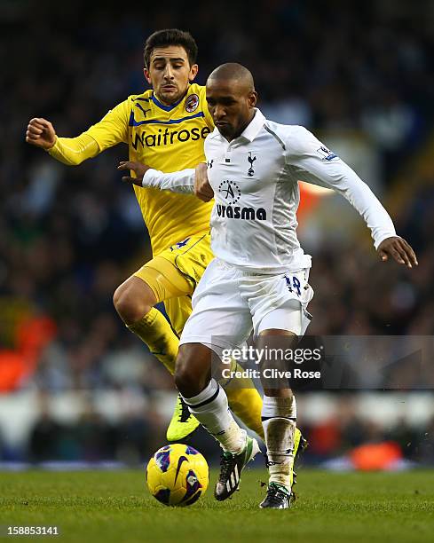 Jem Karacan of Reading and Jermain Defoe of Tottenham Hotspur battle for the ball during the Barclays Premier League match between Tottenham Hotspur...