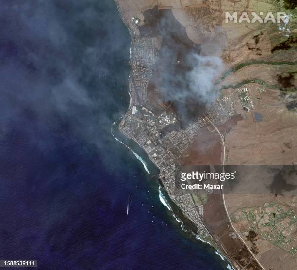 Maxar overview satellite imagery after the Lahaina Wildfire still showing smoldering smoke. Please use: Satellite image 2023 Maxar Technologies.