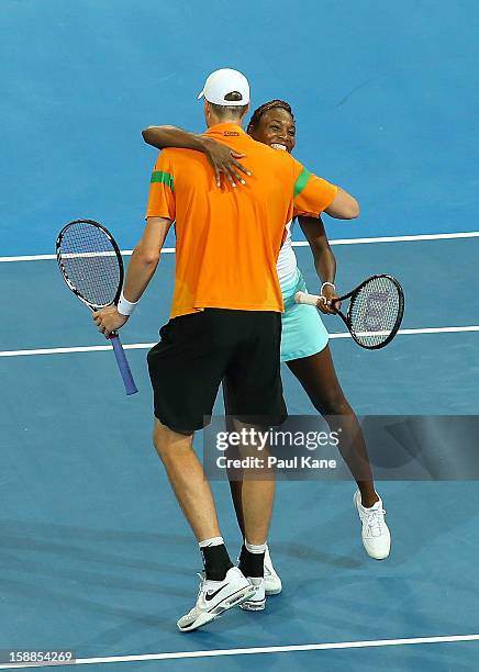 Venus Williams and John Isner of the USA celebrate defeating Mathilde Johansson and Jo Wilfried Tsonga of France in the mixed doubles match during...