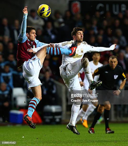 Pablo Hernandez of Swansea City is struck in the face by the boot of Chris Herd of Aston Villa as he clears the ball during the Barclays Premier...