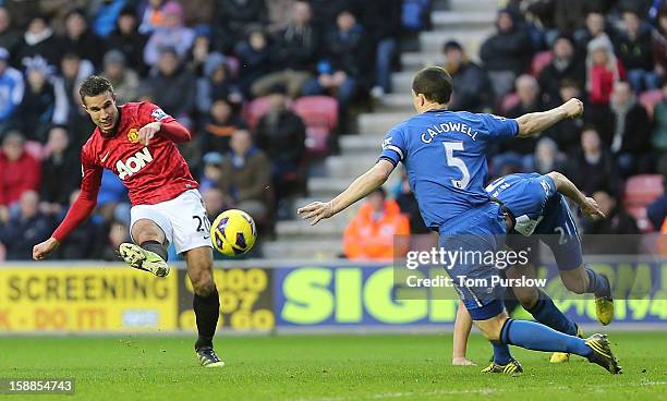 Robin van Persie of Manchester United scores their second goal during the Barclays Premier League match between Wigan Athletic and Manchester United...