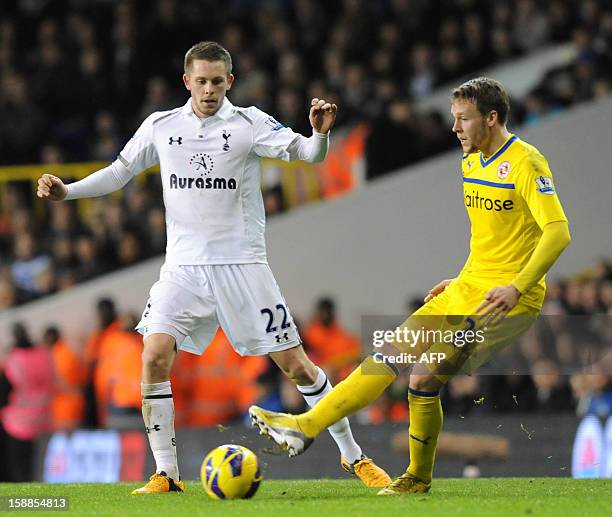 Tottenham Hotspur's Icelandic midfielder Gylfi Sigurdsson vies with Reading's Welsh defender Chris Gunter during the English Premier League football...