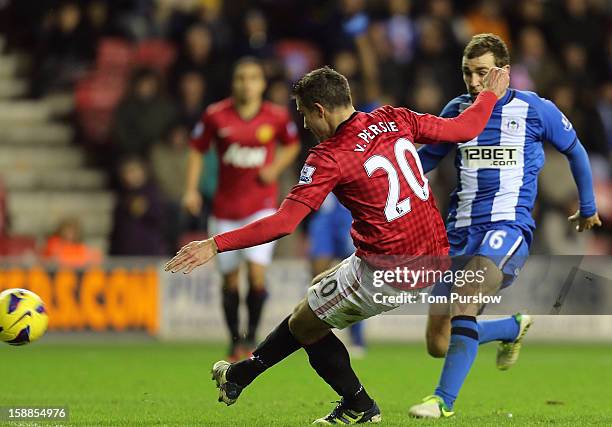 Robin van Persie of Manchester United scores their fourth goal during the Barclays Premier League match between Wigan Athletic and Manchester United...