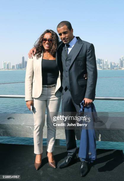 Lucas Moura of PSG holds a shirt as he poses with his mother Maria de Fatima during his official unveiling as a player of Paris Saint-Germain at a...