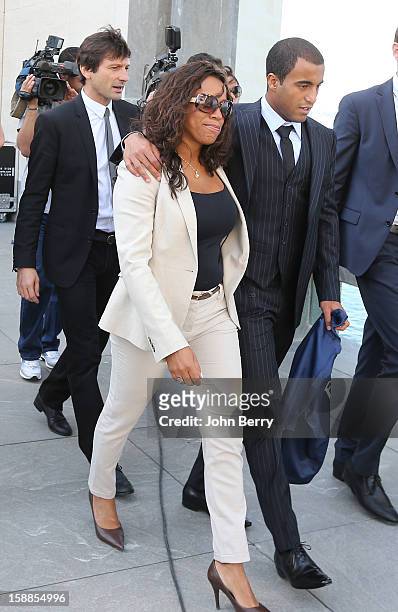 Lucas Moura of PSG walks with his mother Maria de Fatima and Leonardo, manager of PSG, during his official unveiling as a player of Paris...