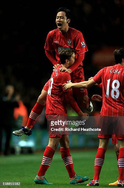 Gaston Ramirez of Southampton celebrates with teammate Maya Yoshida after scoring the opening goal during the Barclays Premier league match between...