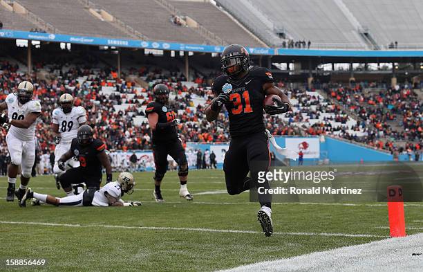 Jeremy Smith of the Oklahoma State Cowboys runs for a touchdown against the Purdue Boilermakers during the Heart of Dallas Bowl at Cotton Bowl on...