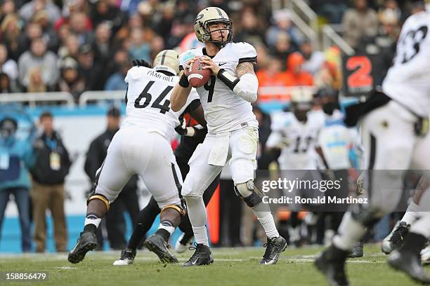 Robert Marve of the Purdue Boilermakers passes against the Oklahoma State Cowboys during the Heart of Dallas Bowl at Cotton Bowl on January 1, 2013...