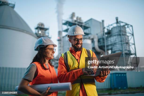 male and female engineers working on the station. - refinery stock pictures, royalty-free photos & images