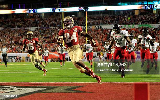 Lonnie Pryor of the Florida State Seminoles scores a 60-yard rushing touchdown in the first quarter against the Northern Illinois Huskies during the...