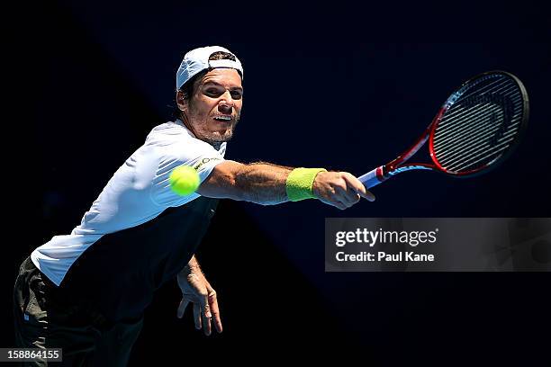 Tommy Haas of Germany plays a backhand to Andreas Seppi of Italy in his singles match during day five of the Hopman Cup at Perth Arena on January 2,...