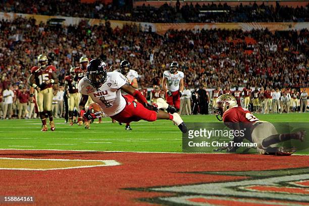 Martel Moore of the Northern Illinois Huskies scores an 11-yard touchdown reception in the third quarter against Lamarcus Joyner of the Florida State...