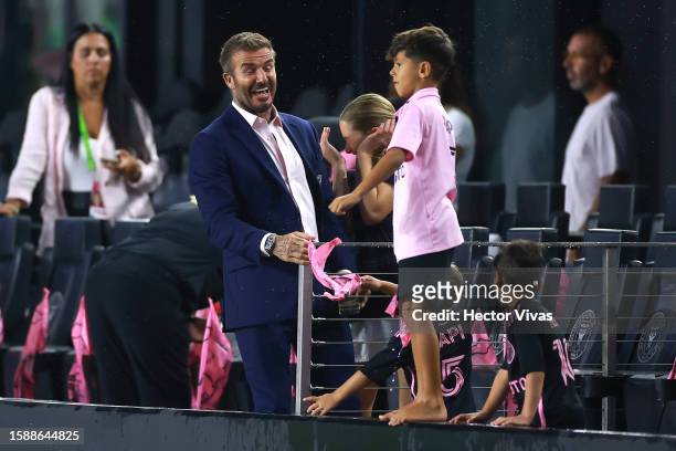 Co-owner David Beckham of Inter Miami CF reacts as the sons of Lionel Messi throw water soaked items following a severe weather delay prior to the...