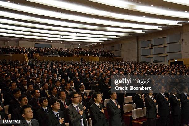 Hyundai Motor Co. Employees salute during a new year company meeting in Seoul, South Korea, on Wednesday, Jan. 2, 2013. Hyundai Motor and smaller...